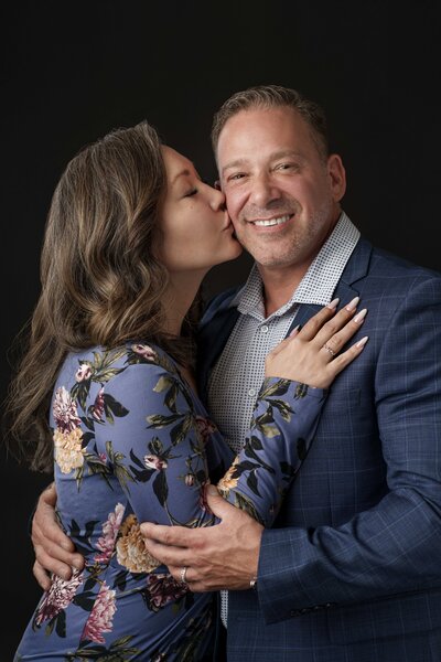 Puyallup Family Photographer Mom kisses Dad in couples portrait