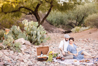 Couple enjoy a picnic during their engagement session in Austin, Texas. Photo taken by Austin Engagement Photographers, Joanna & Brett Photography