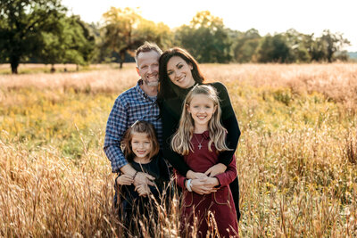 Family standing in a field in Stamford, CT for their session