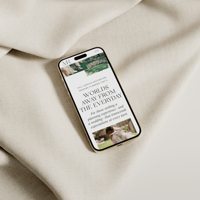 An iPhone laying on linen.