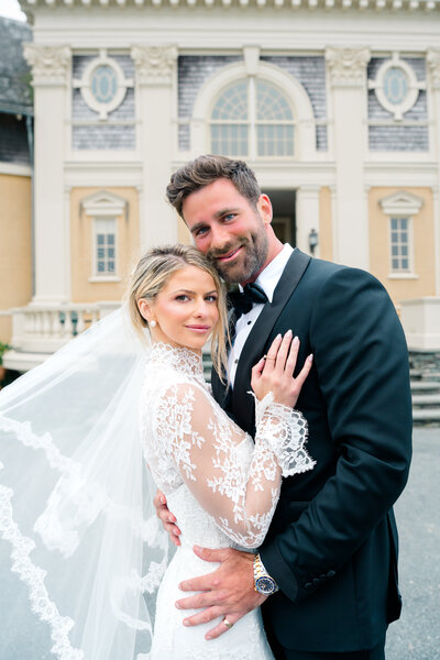 Newport Wedding Photographer | Rhode Island Caprio Captured Photography | Couple Kissing While The Woman Is Sitting On A Trunk of A Vintage Car
