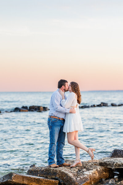 couple embracing infront of flowering bush