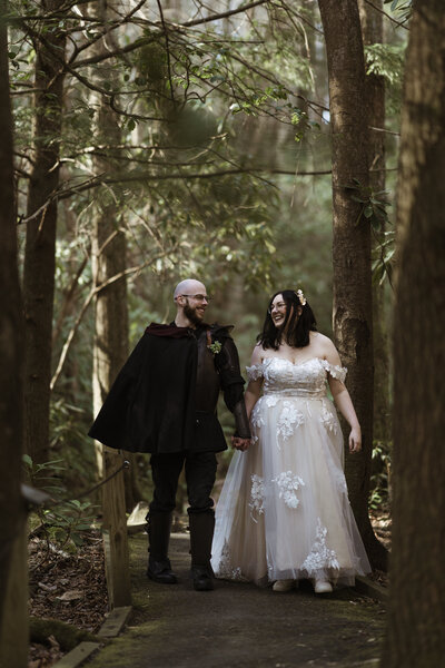 Bride and groom face each other during their ceremony overlooking beautiful mountains and a gorge