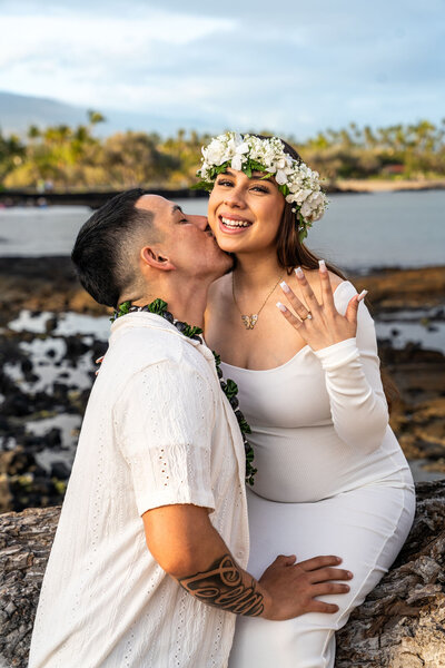 Detail photo of a couple wearing traditional Hawaiian leis during a beach proposal at ʻAnaehoʻomalu Bay in Waikoloa, photographed by Hawaii Adventure Portraits, a Big Island proposal photographer