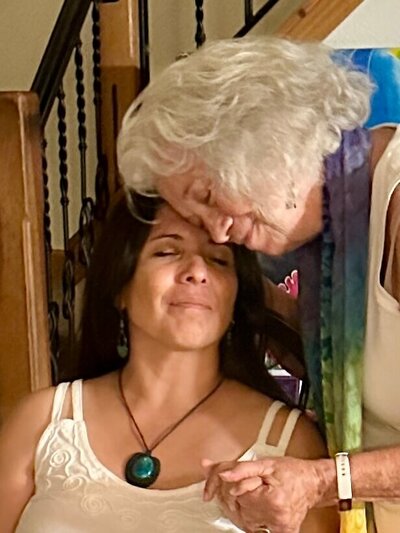Samarah Grace and client leaning togetherwith eyes closed