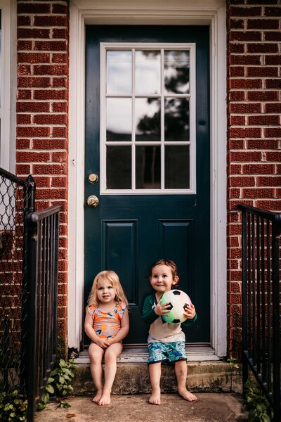 Little Kids Sitting in the doorway
