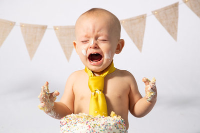 Baby does not want to get messy with his cake