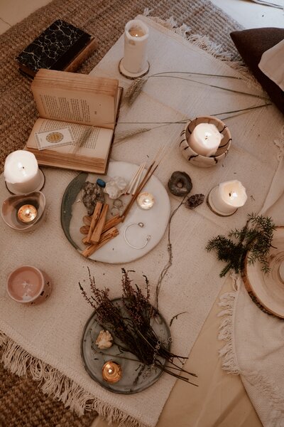 top shot of candles a book and incense