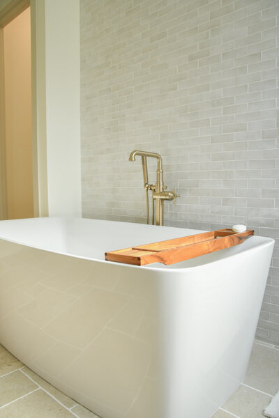 Spacious master bathroom featuring a freestanding soaking tub, glass walk-in shower, and elegant tilework in a custom home by Ryan Noble Construction.