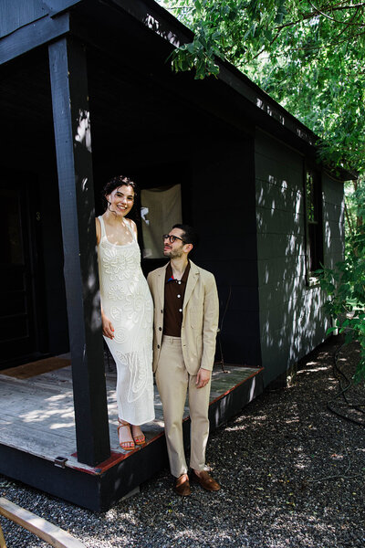 Bride and groom smiling with their heads together and arms around each other