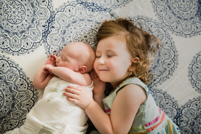 sister holding her baby brother