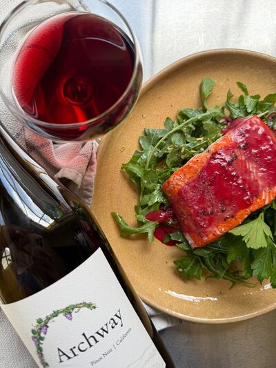 ginger plum salmon with arugula salad and wine