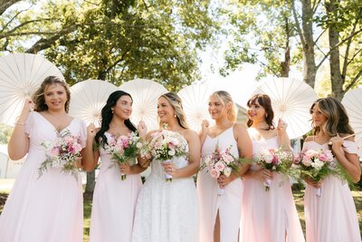 Bride and bridesmaids holding parasols at Battle Mountain Farms wedding