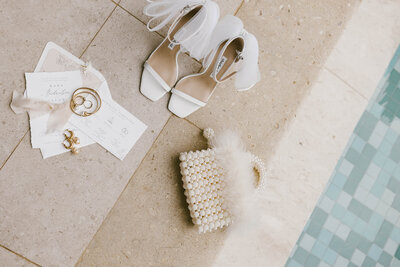 Bohemian wedding flatlay with shoes rings and invitations