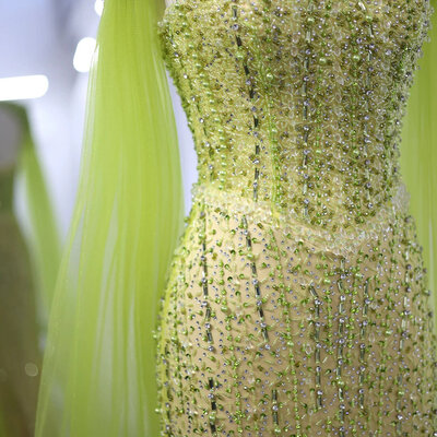 Bridesmaid dress in lime yellow color covered by green diamonds