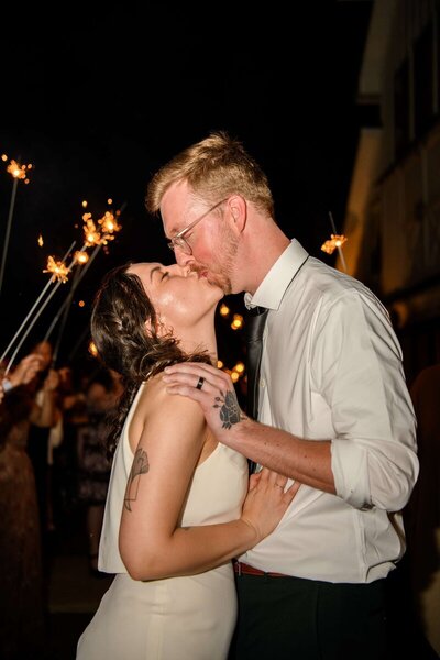 Shelly and Channing kiss during their reception send-off with sparklers in the background