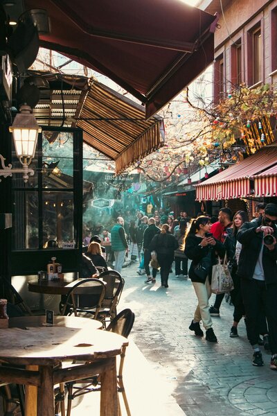 Busy café scene with people walking under hanging lights
