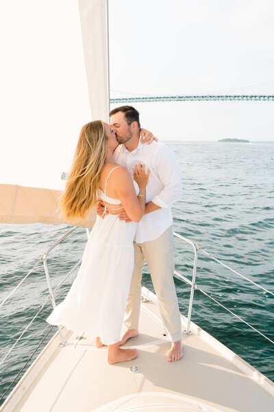 Newport Wedding Photographer | Rhode Island Caprio Captured Photography | Couple Sitting At A Sailboat Looking At The Ocean