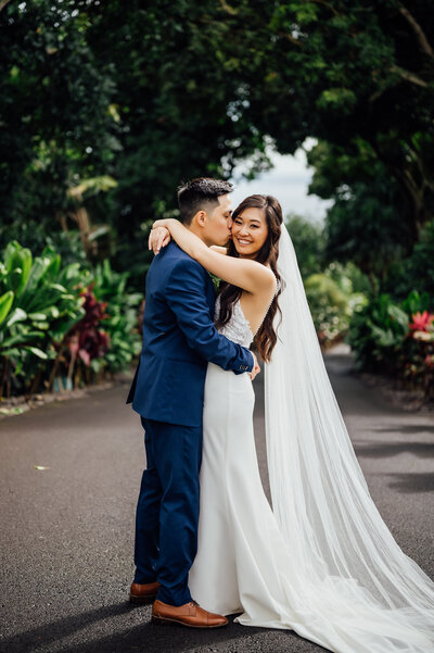 groom kisses the bride during their big island wedding
