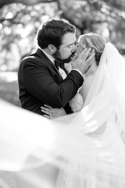 Dramatic wedding portrait couple behind veil