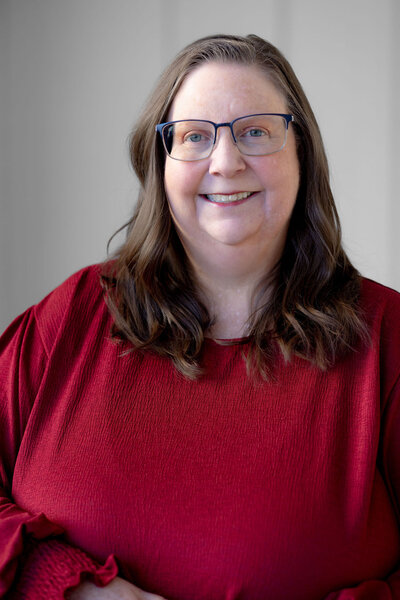 woman in red smiling at camera