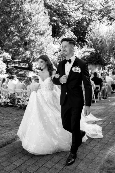 Newlywed bride and groom walking out of ceremony at Abernethy Center in Oregon City, Oregon