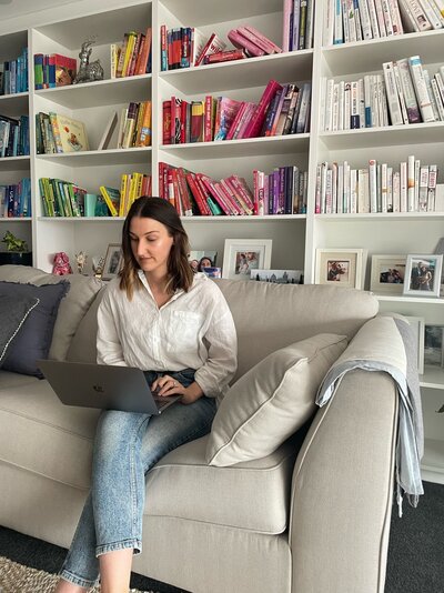 Nutritionist reading a book in  front of bookshelf