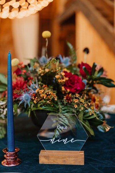 Bright colored florals and glass table numbers