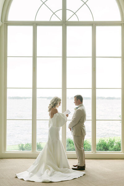 bride and groom reading their vows at bentwater yacht club