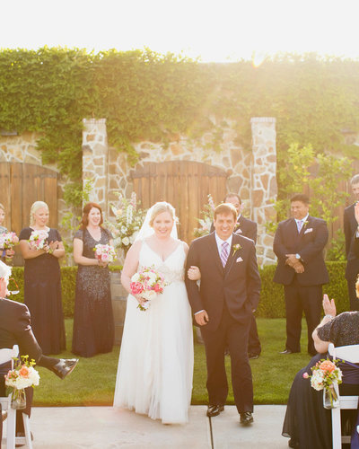 Couple walks away from the altar arm in arm