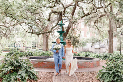 A tender, romantic moment shared between the bride and groom during their Forsyth Park elopement in Savannah.
