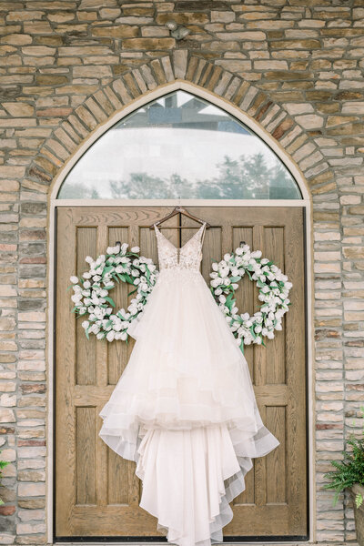 photo of wedding dress hanging on church door