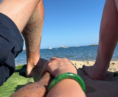 Photo of a couple holding hands at the beach