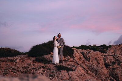 elopement couple holding each other at sunrise