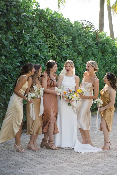 Bridesmaids and brides all showing off their florals.