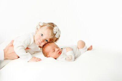Newborn photos, big sister snuggling baby brother, Fresno, Clovis, photographer