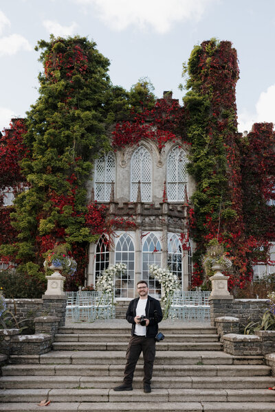 Danny holding camera outside castle