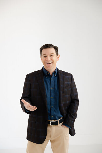 Male in suit smiling at camera.