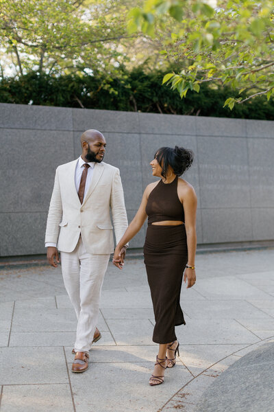 Couple laughing while strolling through DC monuments