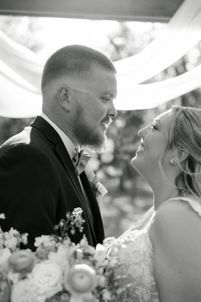 Image captured by Sarasota photographers of bride and groom gazing into each other's eyes in just married bliss.