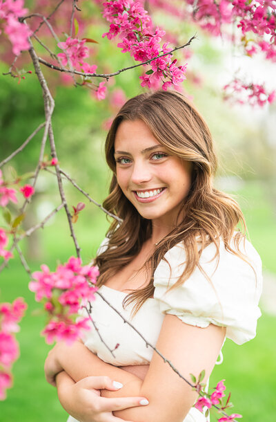 high school senior girl sitting in flower field