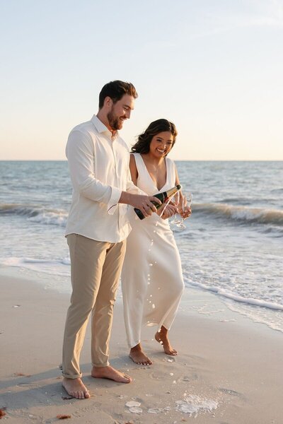 couple drinking champagne on beach to show wedding photography naples fl