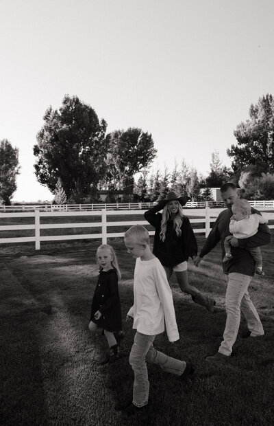 Girl walking away from the camera in a lake at sunset.