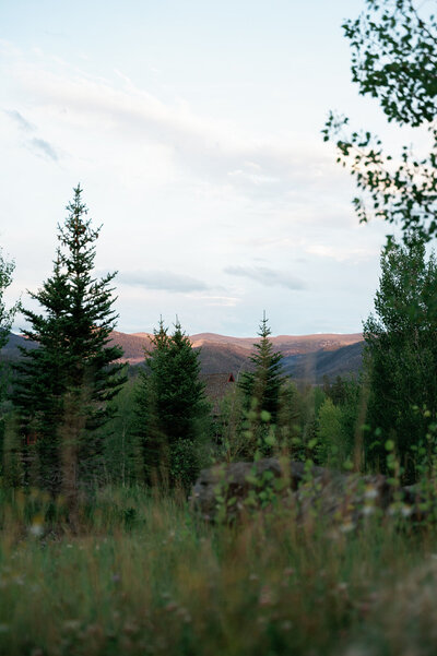 Sunset over the Rocky Mountains with panoramic views at Devil’s Thumb Ranch.