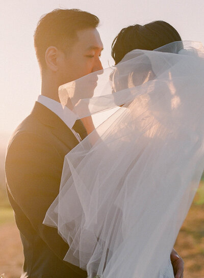 A sunset portrait of an aisan bride and groom at Newcastle Golf Club