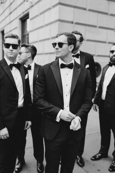 Black and white photo of groom and groomsmen wearing sunglasses