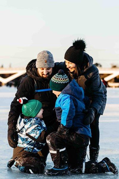 Family of four embracing each other on the Rideau Canal  in Ottawa, Ontario