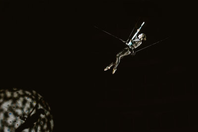 Performer in flight in low light