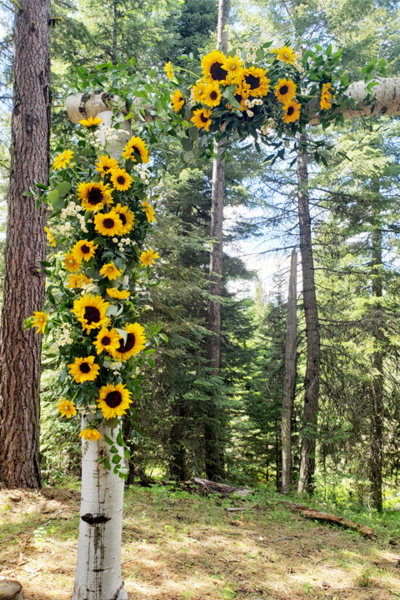 Country wedding with sunflowers on aspen arch