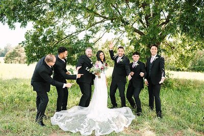 charlotte wedding photographers capture a photo of a playful group of groomsmen with a bride